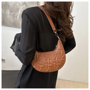 Brown crescent shoulder bag with geometric woven texture shown on model for daily style