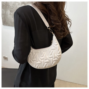 Chic white crescent shoulder bag with 3D geometric texture and gold metal hooks