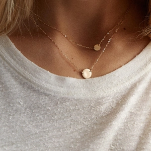 Double-layered stainless steel necklace featuring gold round pendants and fine link chains
