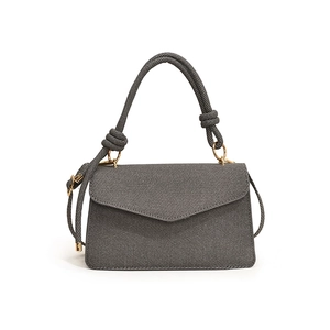 Chic dark gray twill handbag with braided rope handle and long shoulder strap on white