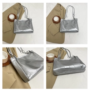 Detail of silver patchwork tote bag showing metallic texture and modern shoulder straps