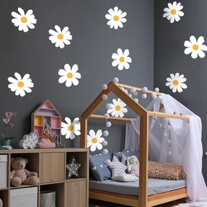 Daisy wall stickers applied in a cozy bedroom scene with white petals and yellow centers