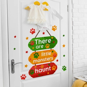 Close-up of little monsters haunt wall decals with stars and paw prints for nursery