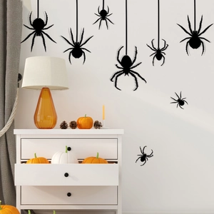 Halloween wall stickers featuring black spider silhouettes on a white wall with pumpkins