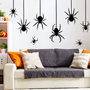 Detail of black spider wall stickers set with hanging webs on modern living room wall