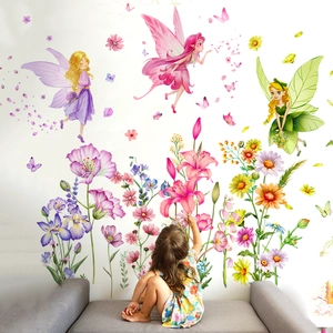 Floral fairy wall stickers applied in a kids room above a sofa with a young girl