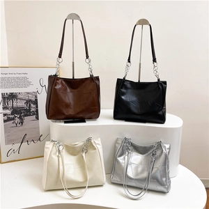 Large geometric tote bags in four colors with stylish metal chain straps and modern texture