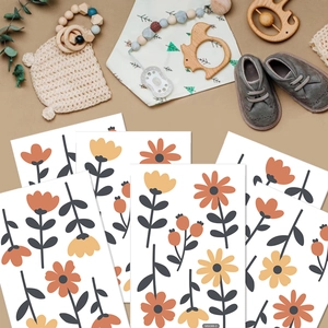 Flat lay of Nordic floral wall stickers set in orange and yellow for nursery decor