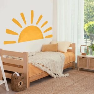 Nursery room wall with warm yellow sun decal and hand-drawn rays in Nordic style decor