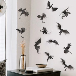 Close-up of 3D black dragon wall stickers with folded wings on a minimalist white wall
