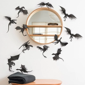 Close-up of 3D black glitter dragon wall stickers surrounding a mirror for Halloween decor