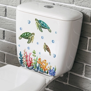 Detail shot of colorful sea turtle and coral stickers on a white ceramic toilet tank
