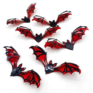 Close-up of 3D Halloween bat wall stickers with red glitter finish and matte black texture