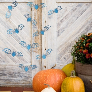 Blue glitter 3D bat wall stickers displayed on a rustic door with autumn pumpkins