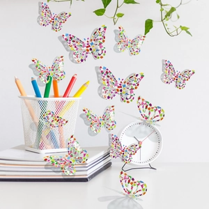 Detailed view of 3D colorful floral butterfly wall decals on a minimalist white desk setup
