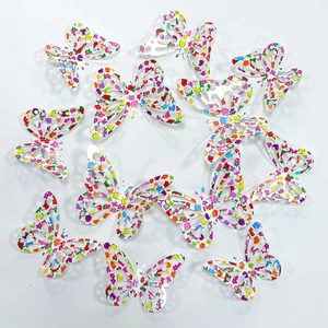 Macro detail of 3D rainbow butterfly wall stickers with hollow floral patterns