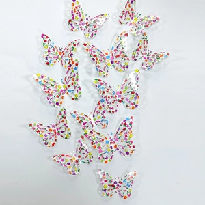 Detailed view of 12-piece colorful 3D hollow butterfly wall stickers with floral patterns