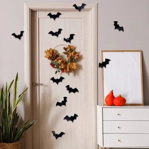 Close-up of 3D black decorative bats placed on modern wall and furniture for Halloween