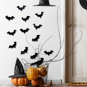 Detailed view of 3D laser-cut black bats on wall with Halloween pumpkin decor