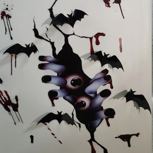 Detail of 3D Halloween wall stickers featuring black bats, bloody handprints, and monster claws