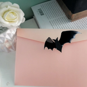 Glossy black 3D bat sticker sealing a light pink envelope for Halloween decoration