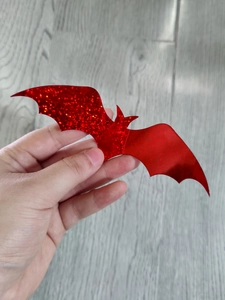 Close-up of red glitter 3D bat wall sticker decoration for Halloween party decor