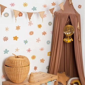 Detail of bohemian small flower wall stickers in a cozy nursery room with earth tones