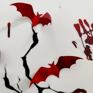 Close-up of 3D red glitter bat wall stickers with laser texture for Halloween decor