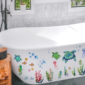 Colorful sea turtle and marine life wall stickers decorating a white modern bathtub side