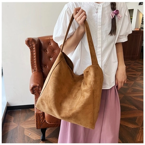 Caramel suede tote bag with large capacity shown in a stylish indoor lifestyle setting