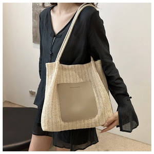 Close-up of the woven texture and fashion leather patch on a beige tote bag