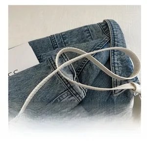 Détail de la bandoulière en cuir blanc avec finitions de couture haut de gamme