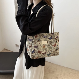 Vintage tote bag with butterfly floral patterns and JINGPINNB label on cream straps