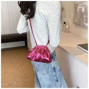 Chic metallic pink mini shell bag with pleated texture and thin shoulder strap