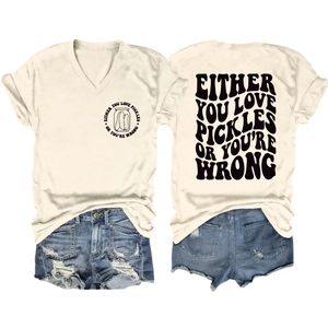 Flat lay of cream V-neck tee with pickle slogan print and distressed denim shorts