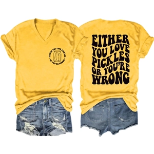 Flat lay of yellow V-neck T-shirt with 'Either You Love Pickles' print and denim shorts