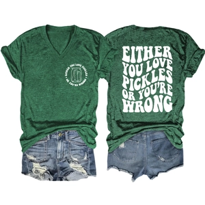 Detail view of V-neck dark green t-shirt with pickles graphic and frayed denim shorts