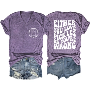 Flat lay of purple V-neck T-shirt with pickles print and distressed denim shorts