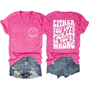 Detail view of hot pink V-neck T-shirt with pickles slogan and distressed denim shorts