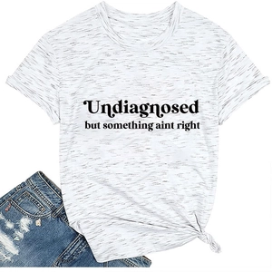 Flat lay of a white crew neck T-shirt with black slogan print and denim shorts