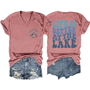 Detail view of pink V-neck t-shirt with Lake theme print and ripped denim shorts