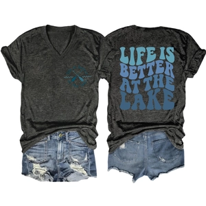 Flat lay of gray V-neck tee with 'Life is Better at the Lake' print and denim shorts