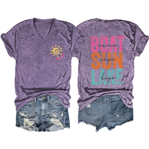 Detail of V-neck purple T-shirt with lake sun rays graphic and distressed denim shorts