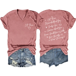 Flat lay detail of pink V-neck T-shirt with white script print and distressed denim shorts