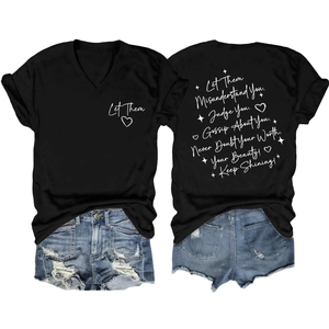 Flat lay of a black V-neck T-shirt with white text and distressed denim shorts in a set