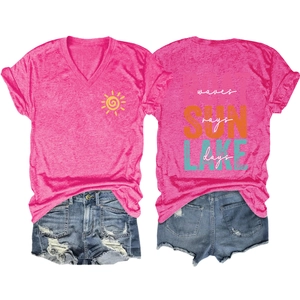 Flat lay of rose pink V-neck T-shirt with lake lettering and distressed denim shorts