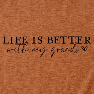 Detail of the Life Is Better with my grands slogan printed on terracotta knit fabric
