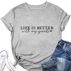 Flat lay of gray T-shirt with Life is better print, denim jeans, and white sneakers