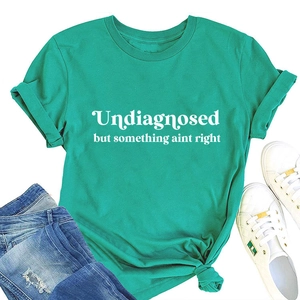 Flat lay of teal cotton t-shirt with white slogan print and casual denim shorts
