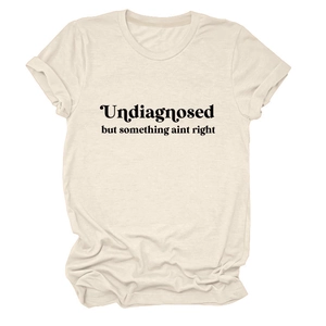 Detail of crew neck t-shirt with 'Undiagnosed' black text print on cream fabric